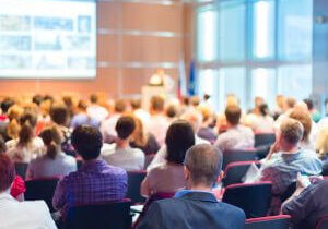 Audience listening to a presenter in a conference room